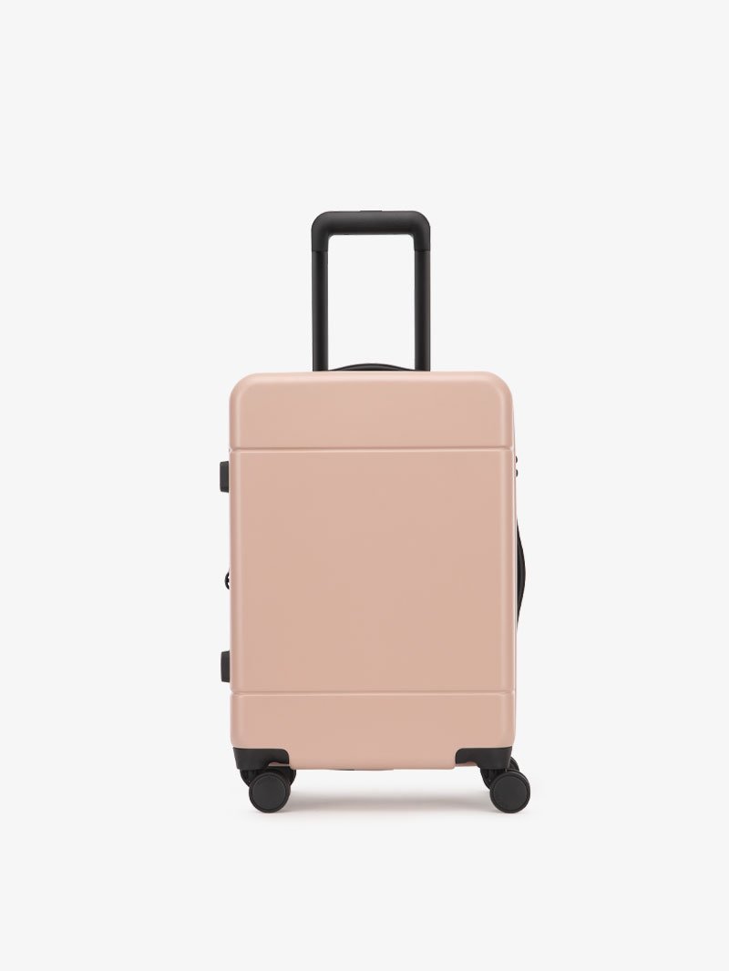 https://www.calpaktravel.com/cdn/shop/products/hue-carry-on-luggage-pink-sand-from.jpg?v=1592504628&em-format=auto